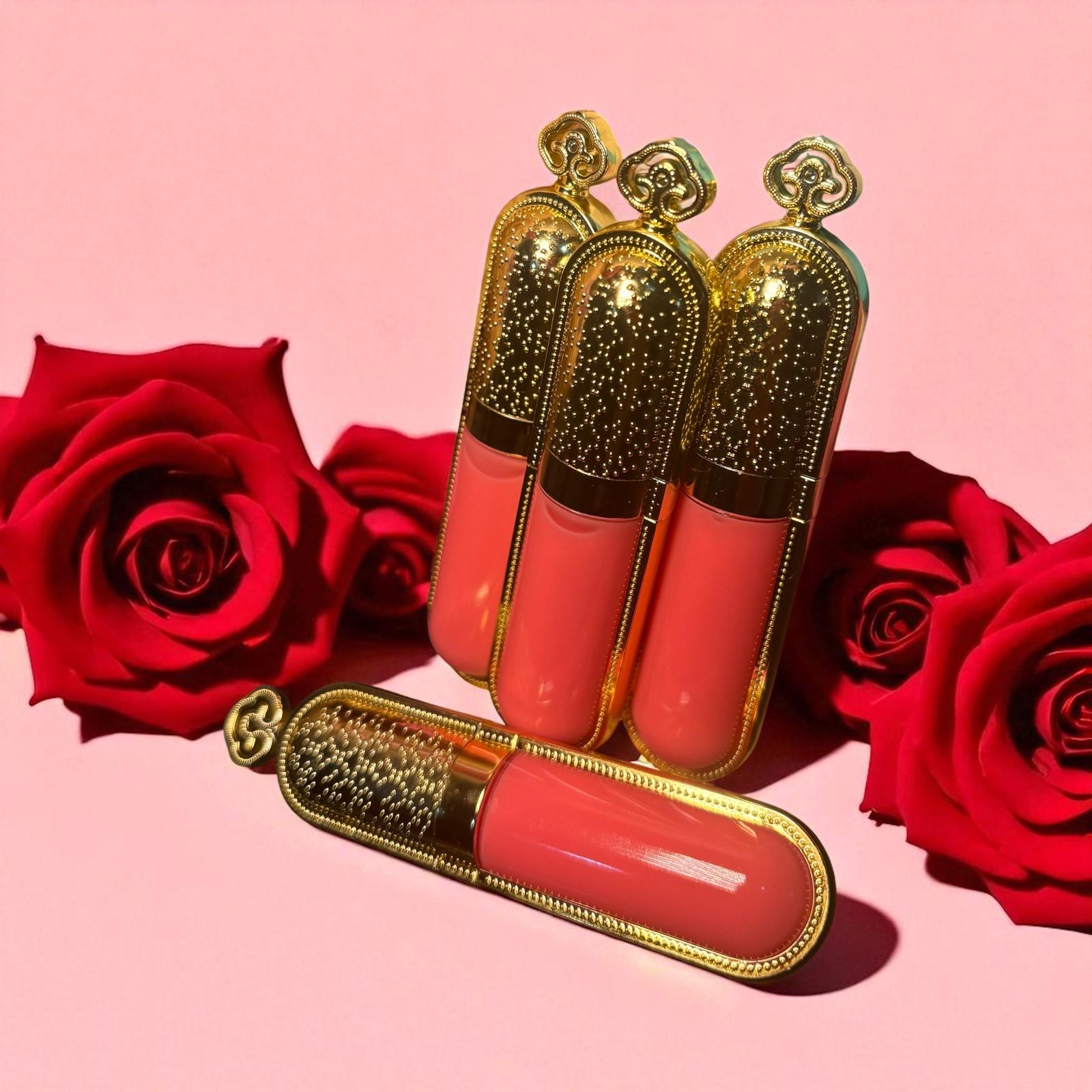 Closeup of glossy lips and lip gloss tubes in rose and plum hues